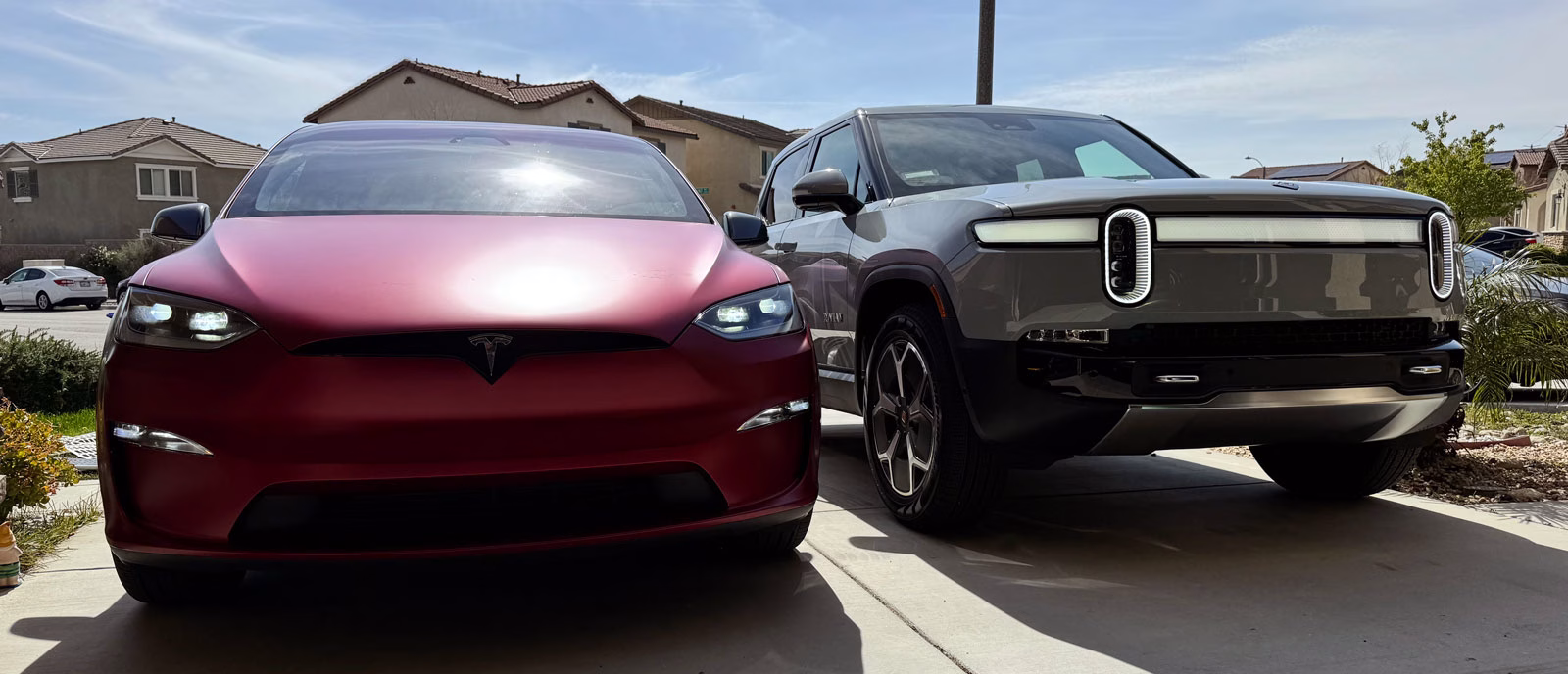 Model X next to Rivian R1T